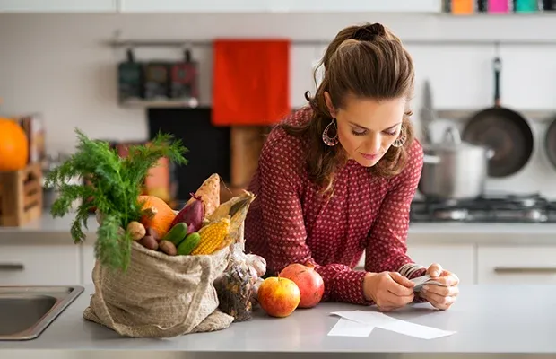 Assorted pantry jars and seasonal produce on a kitchen counter